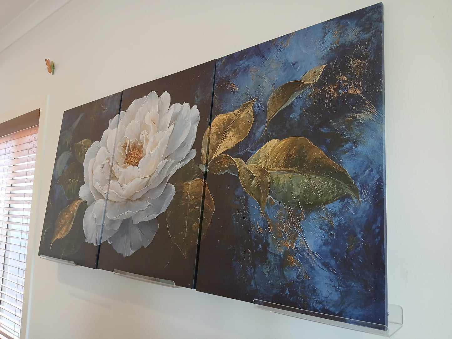 White Floral Canvas Wall Art with Gold Accents on Deep Blue Background